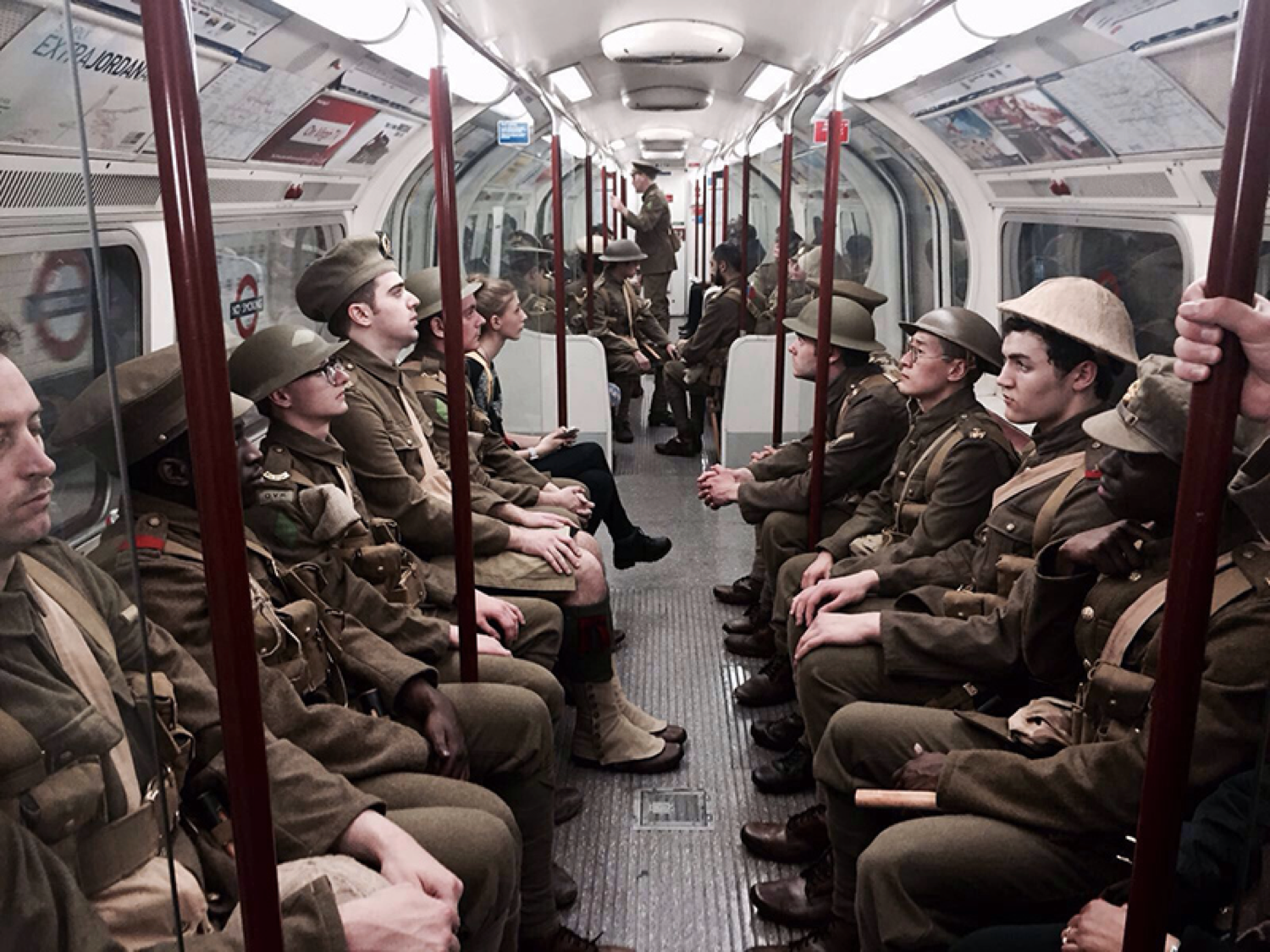A group of men dressed as WWI soldiers sit on the London Underground in 2016.