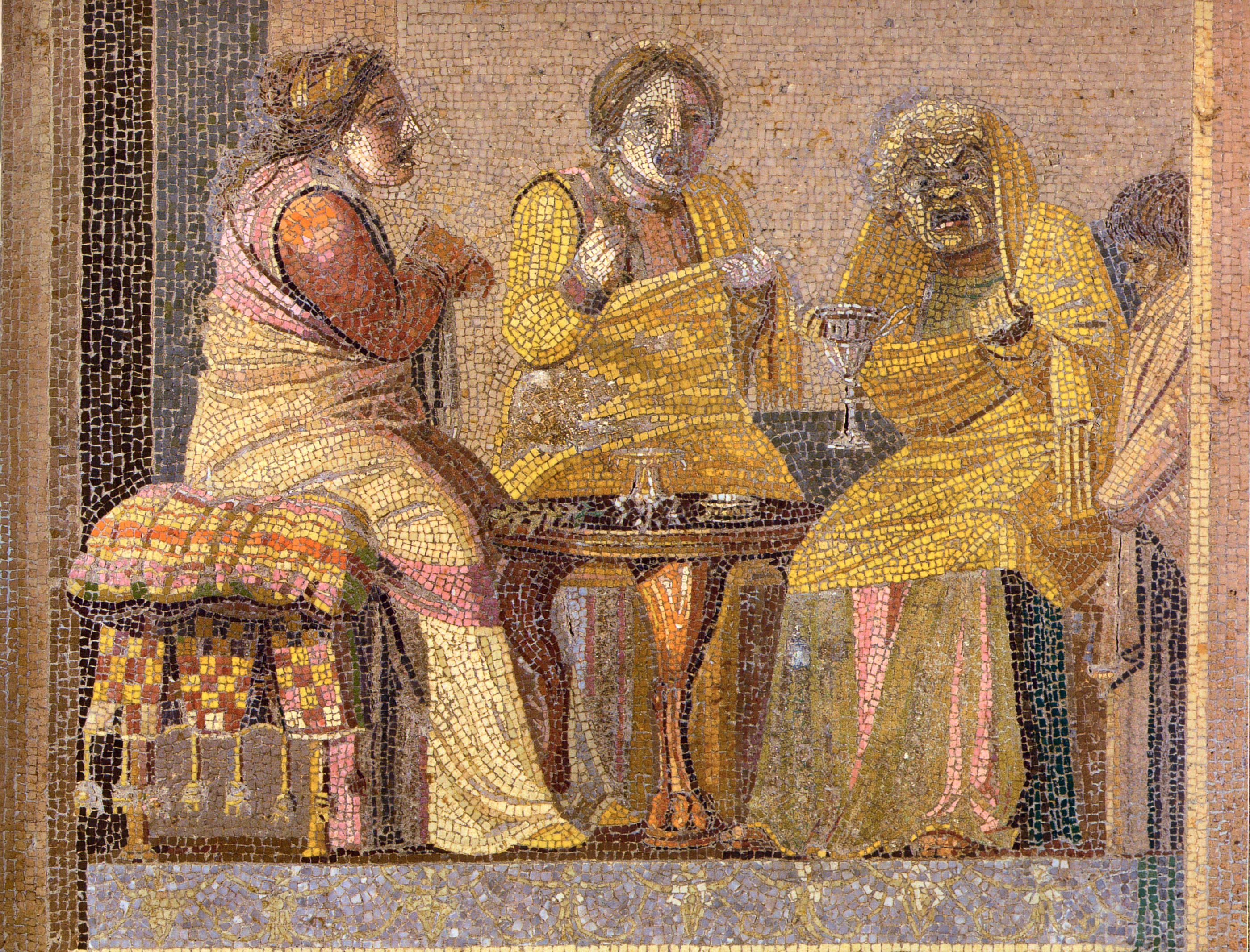 mosaic depicting three female figures wearing comic masks seated at a table